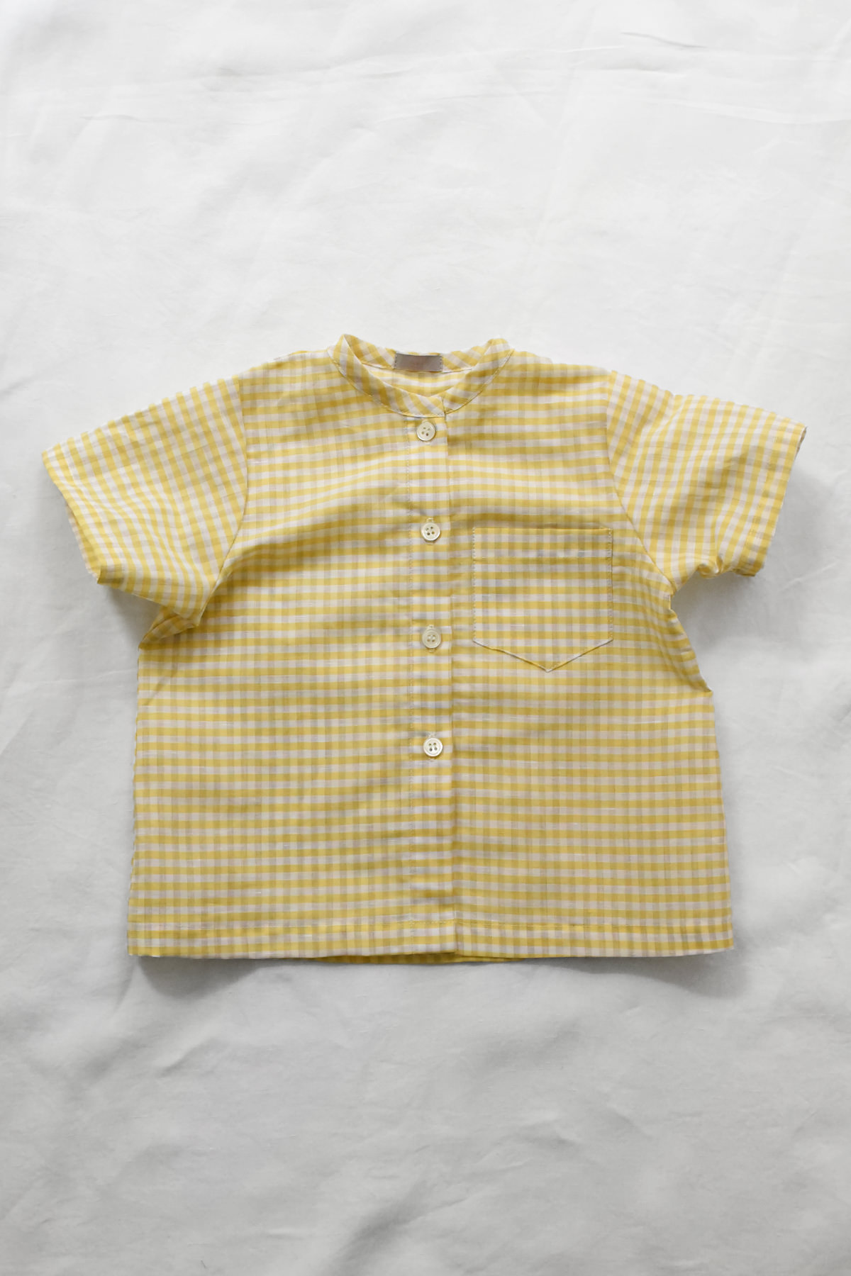 Italian gingham baby shirt in soft yellow with short sleeves and front buttons