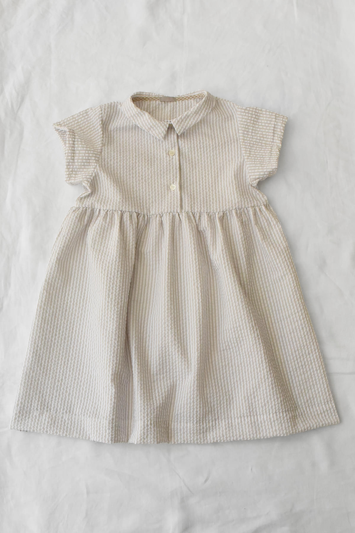 Lightweight beige striped dress with short sleeves and gathered waist