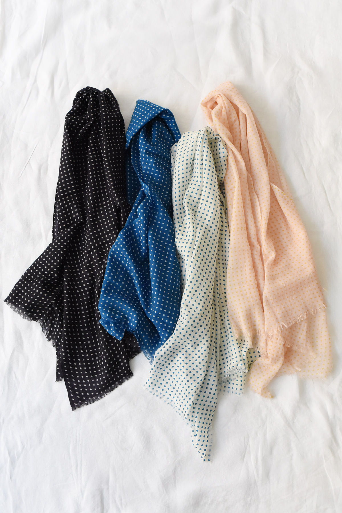 Lightweight cashmere polka dot scarf in navy, indigo, ivory, and peach