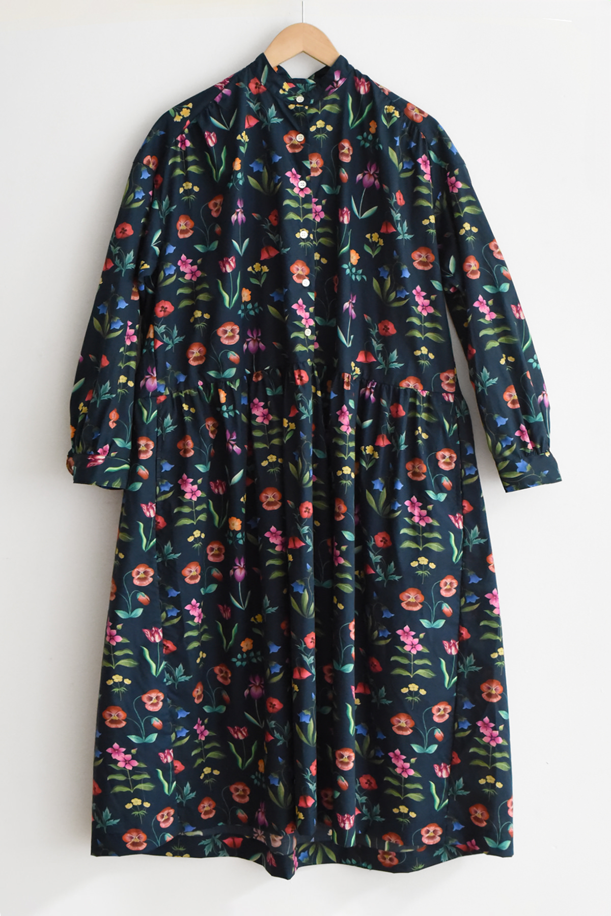 Navy floral cotton dress with stand collar and long sleeves, gathered waist