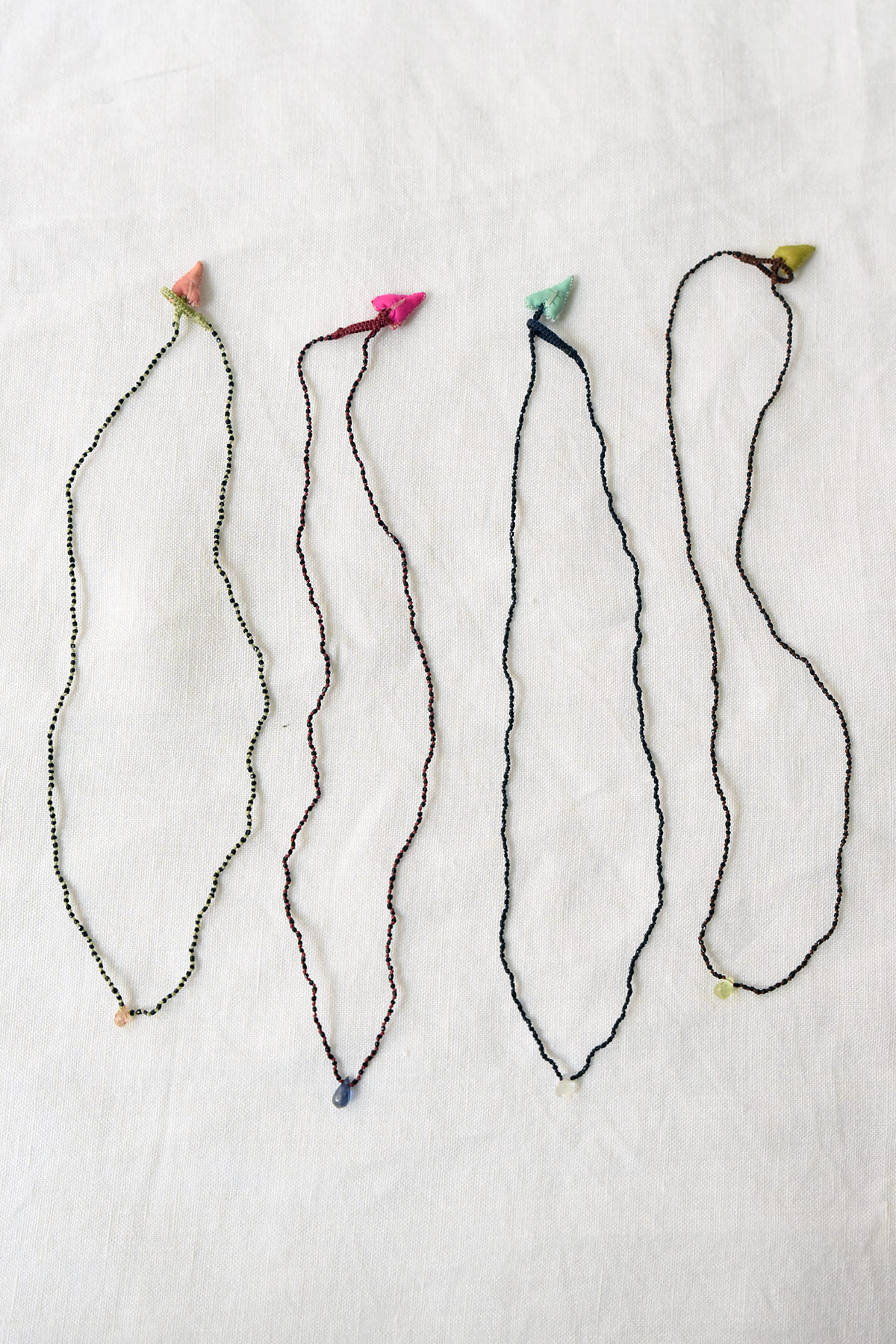 Delicate handmade micro beaded necklace with heart charm closure and stone drop detail