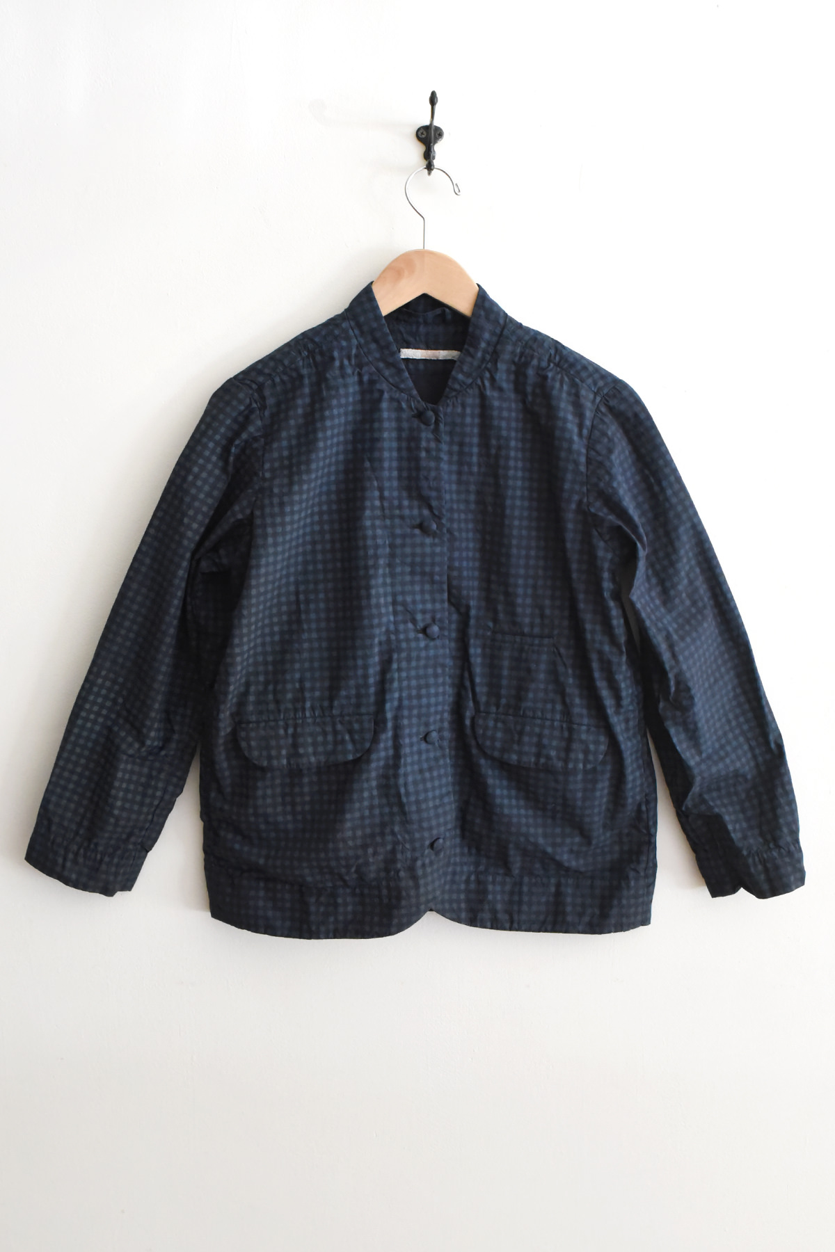 Aodress navy check short jacket with covered buttons, rounded collar, front flap pockets, and cropped silhouette