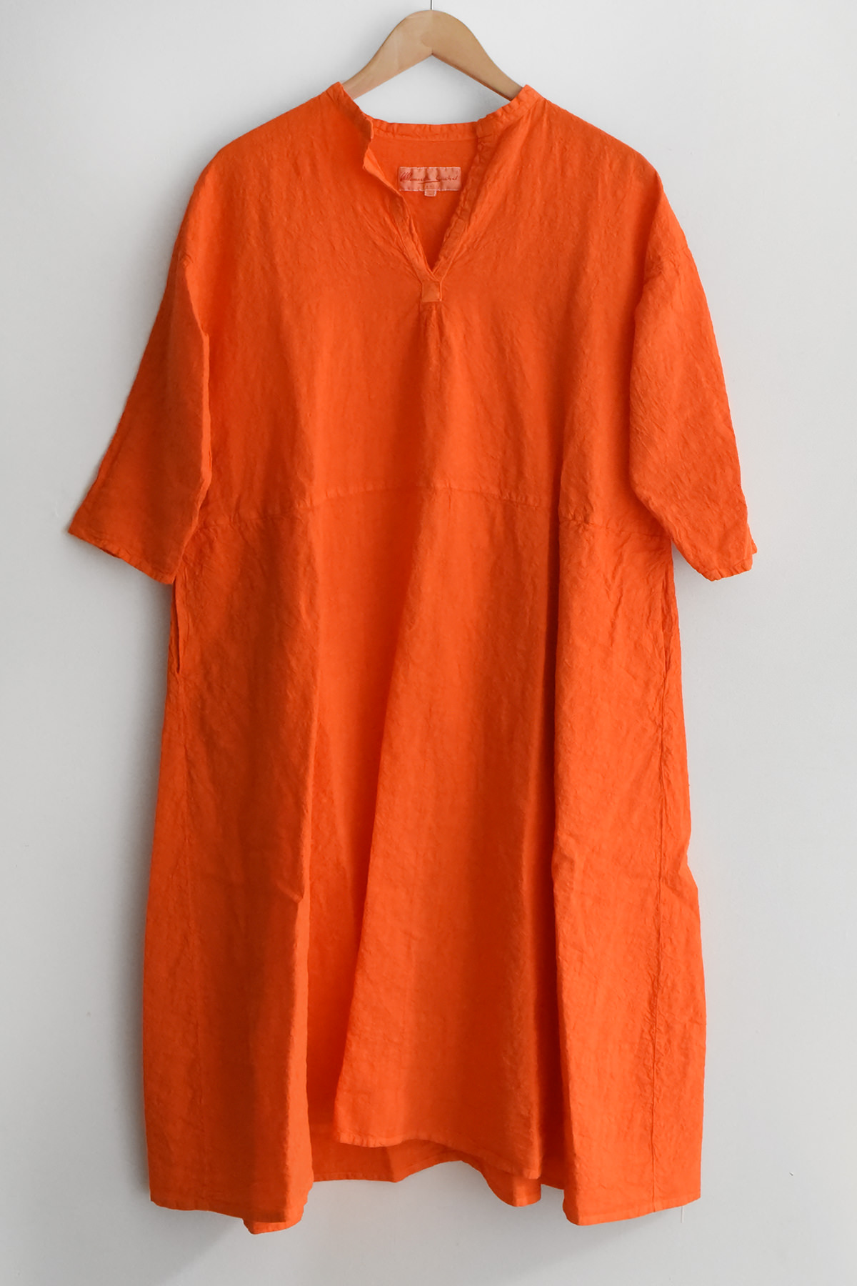 linen short sleeve dress with front slit neckline and side pockets front view