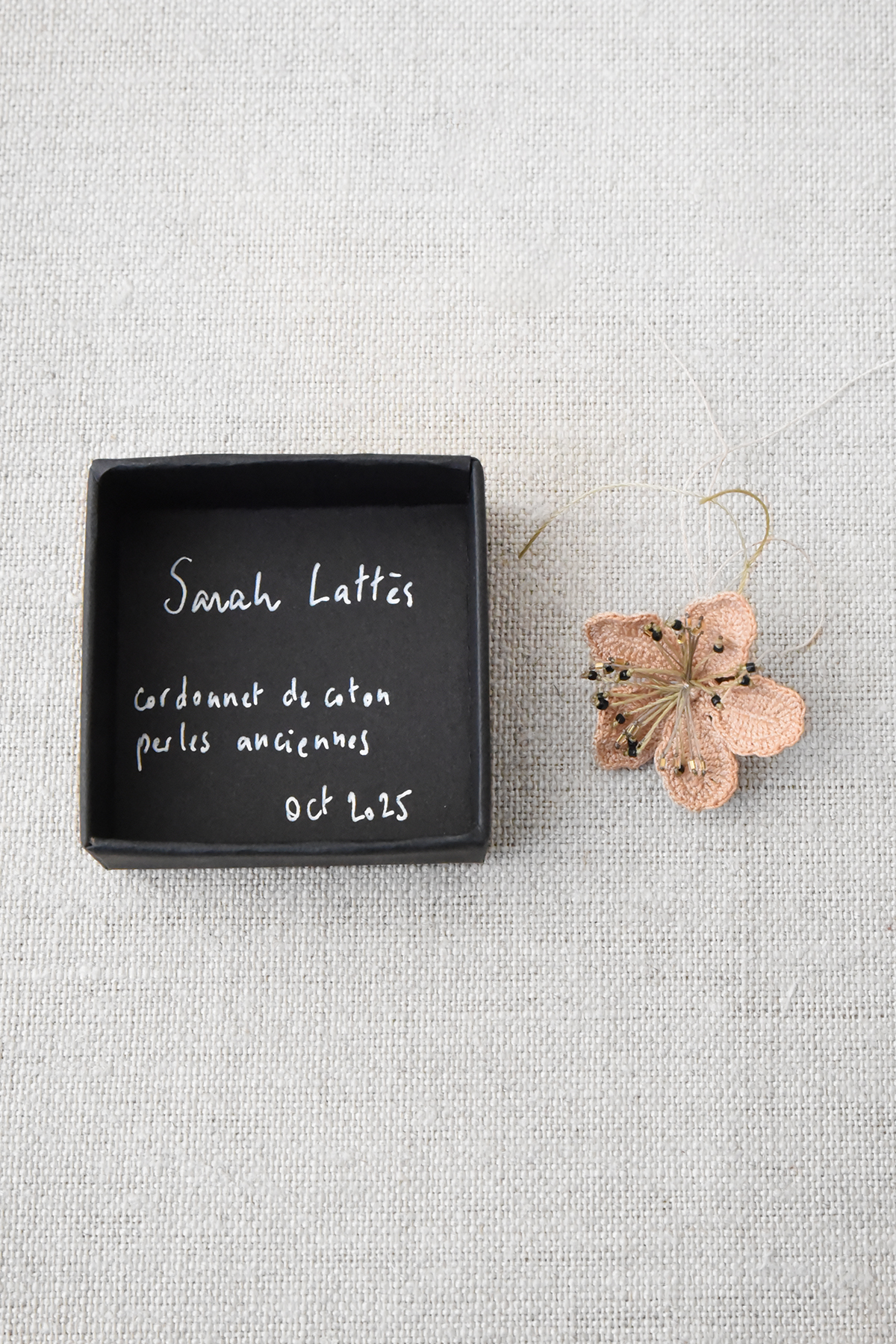 handmade flower brooch with thread and antique bead detail