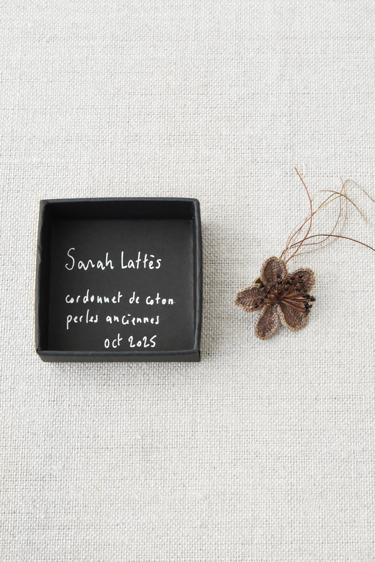 small brown cotton flower brooch close up texture