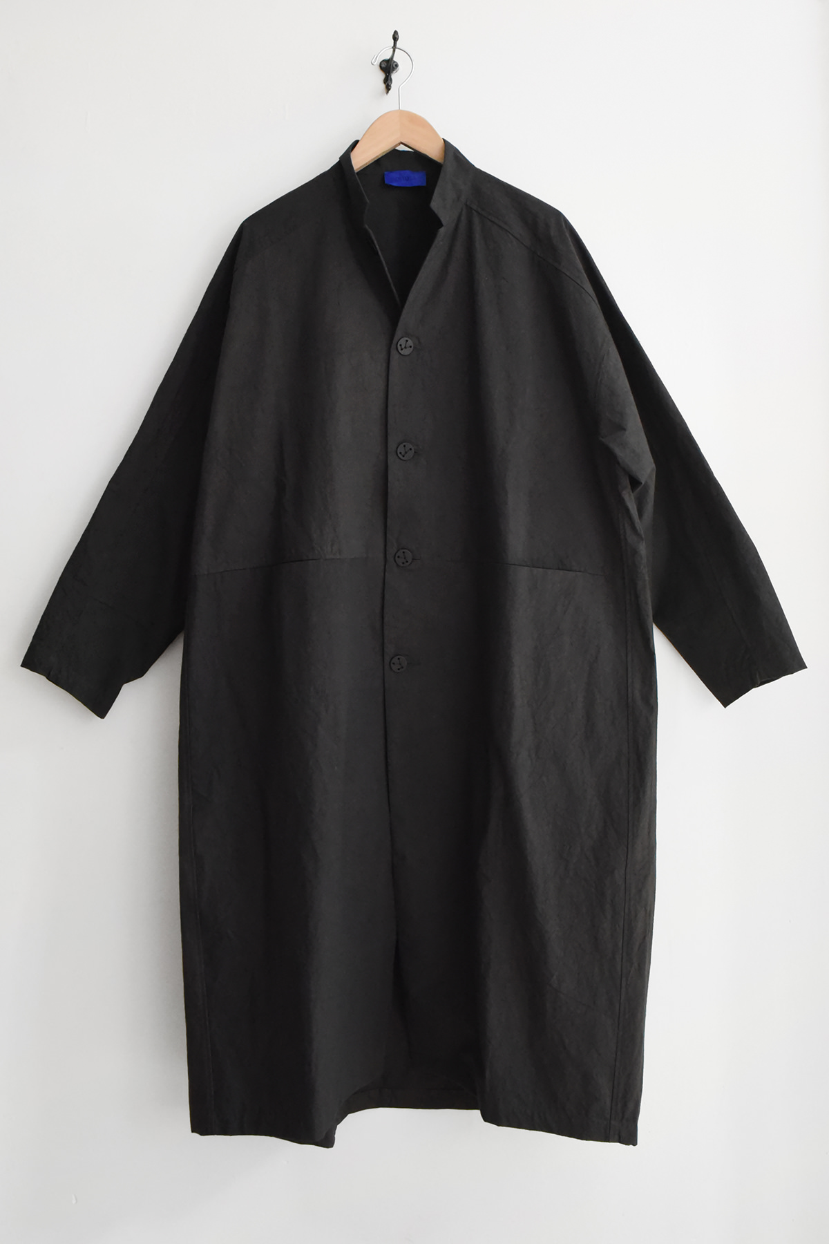 Oyuna Present oversized cotton coat in Japanese woven cotton with curved silhouette and constellation button closure