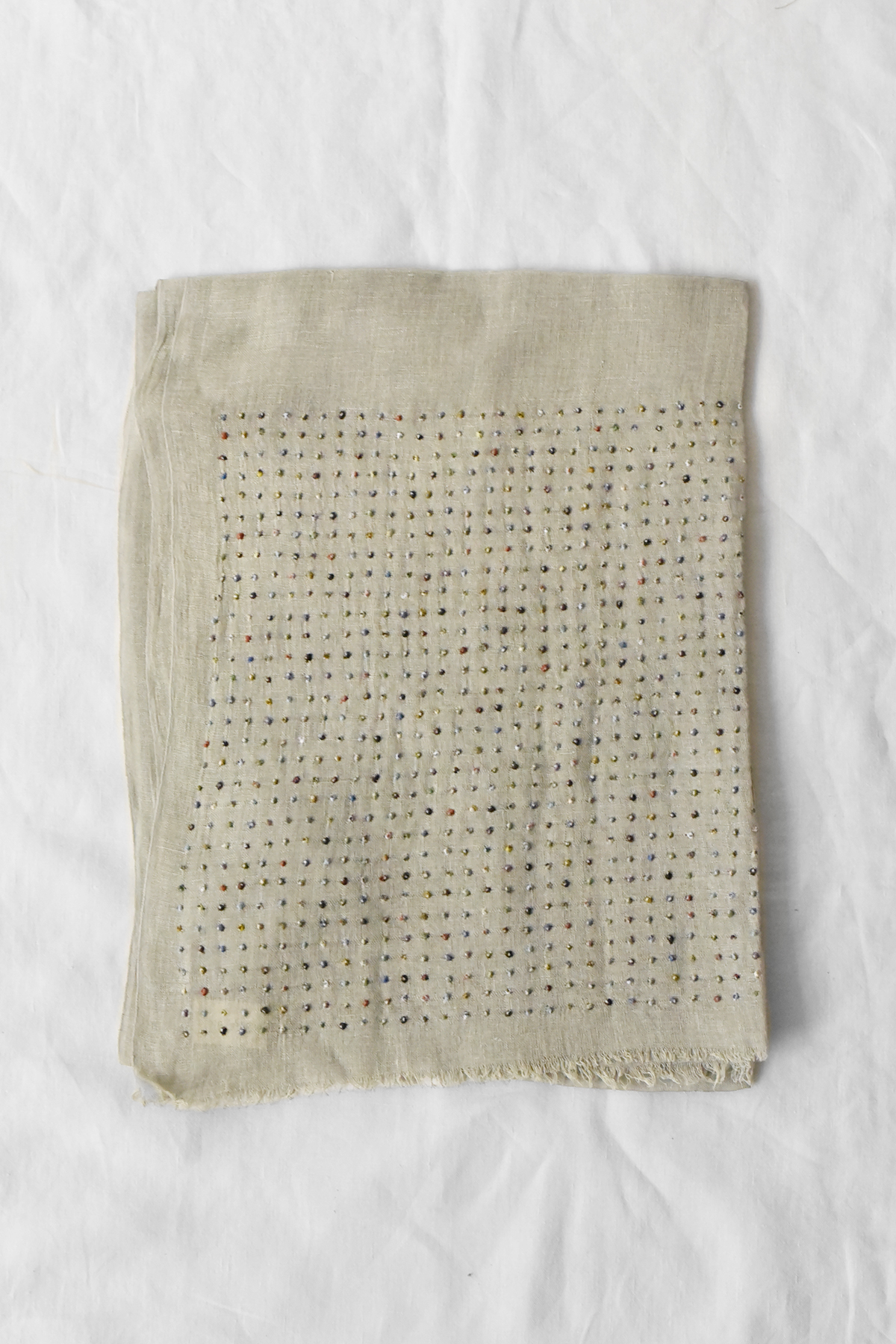 Lightweight linen stole with hand embroidered multicolor dot pattern along both ends and plain center, draped against a neutral background