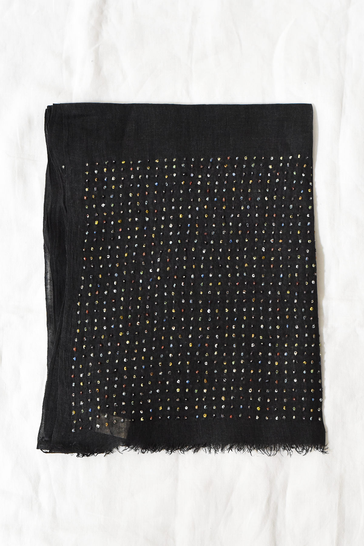 Lightweight linen stole with hand embroidered multicolor dot pattern along both ends and plain center, draped against a black background