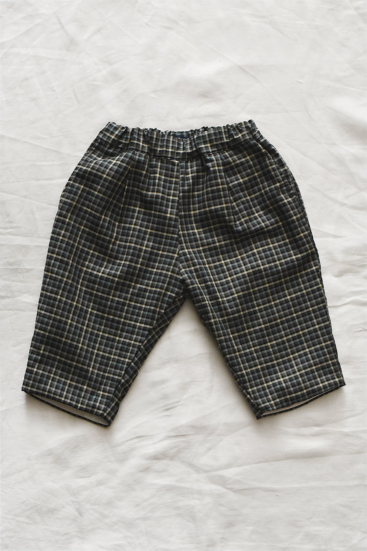 Kids cotton pants with elastic waistband, side pockets, and back pocket.