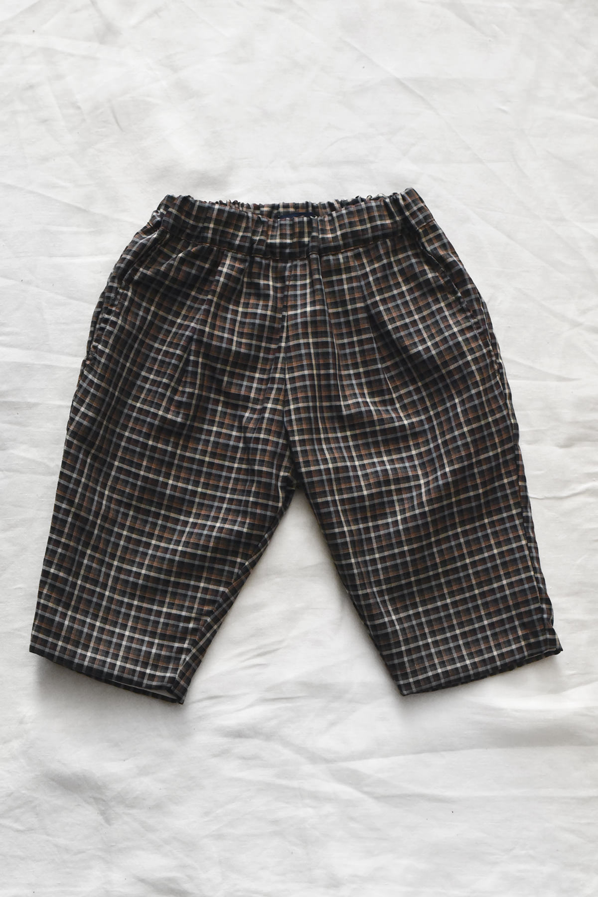 Kids cotton pants with elastic waistband, side pockets, and back pocket.
