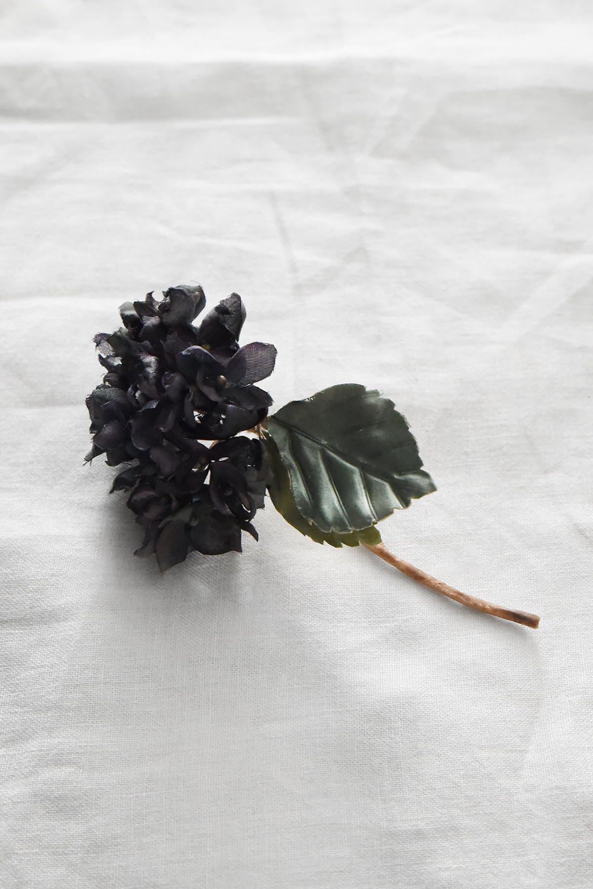 Hand-painted silk hydrangea artwork by Japanese artist Hitoyo featuring deep navy petals, a hand-colored leaf, and botanical detailing