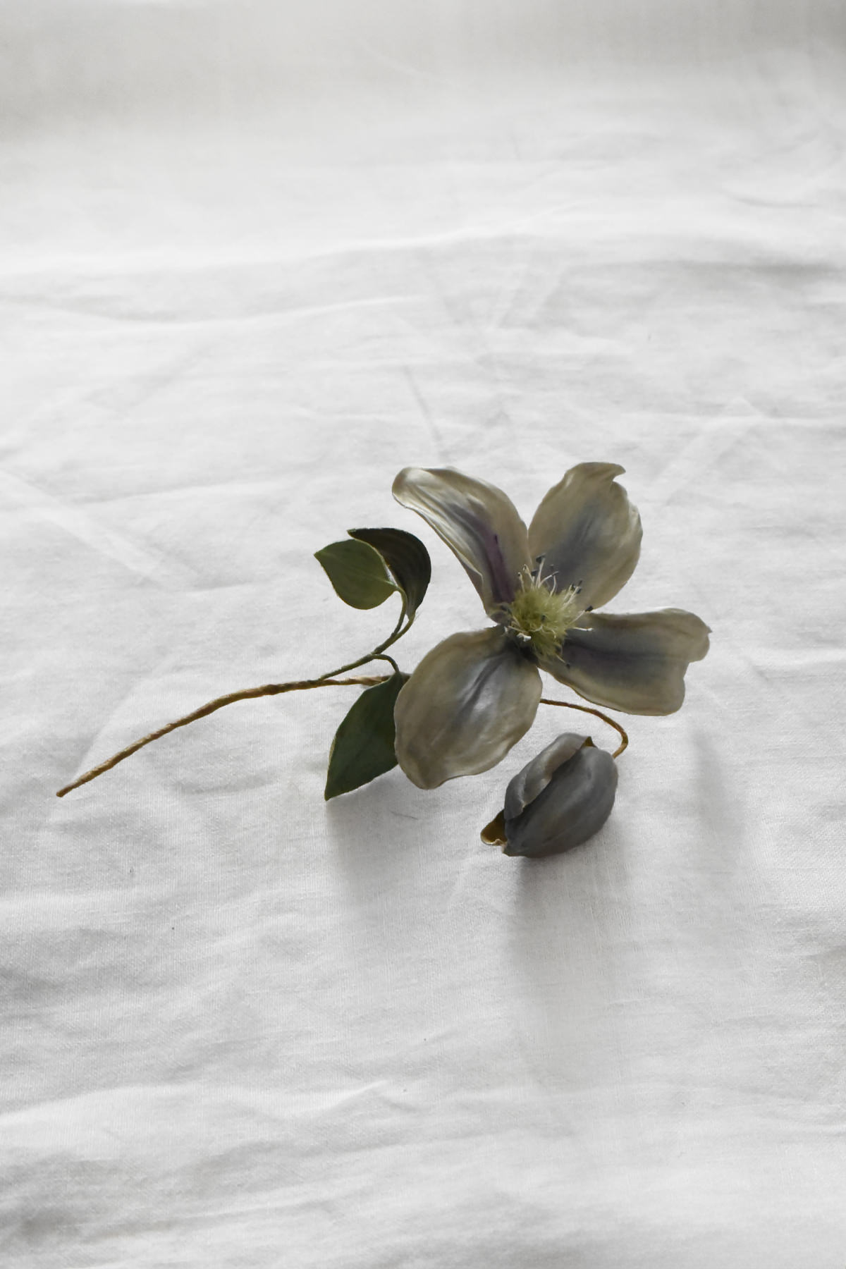 Hand-painted silk clematis flower artwork by Japanese artist Hitoyo with a sculpted bud and delicate painted petals