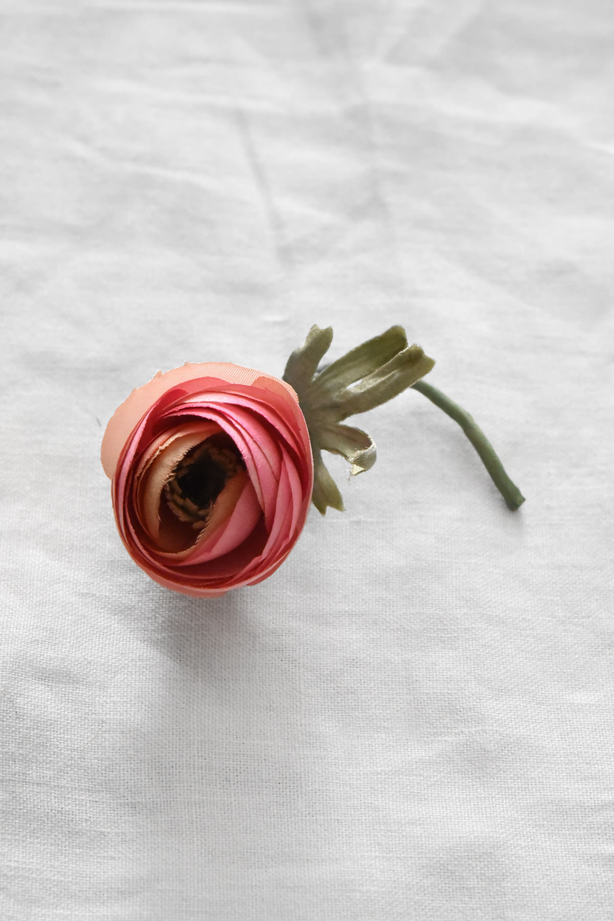 Hand-painted silk ranunculus flower corsage by Japanese artist Hitoyo in soft coral pink tones