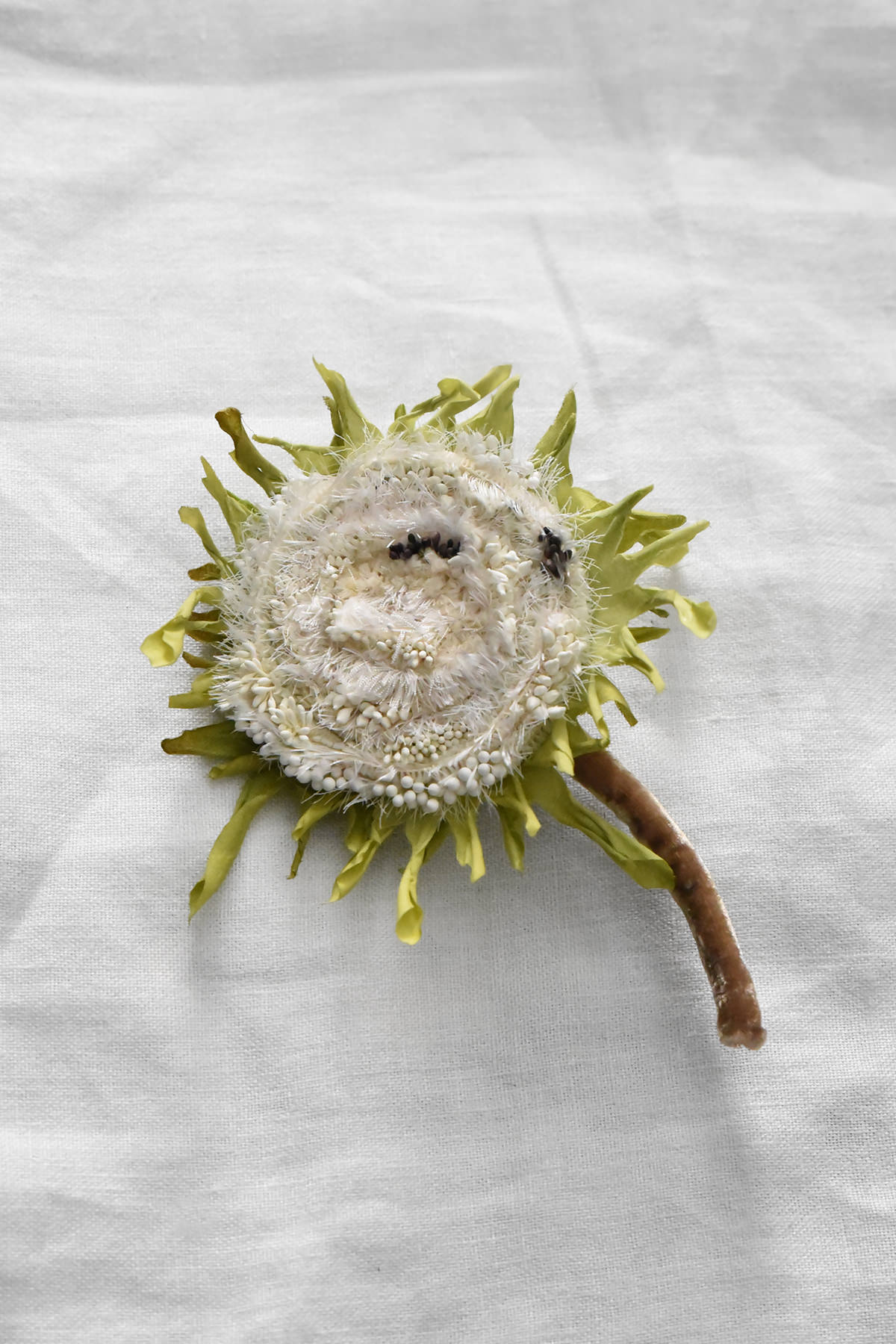 Hand-painted silk sunflower with textured white center and green bracts by Japanese artist Hitoyo