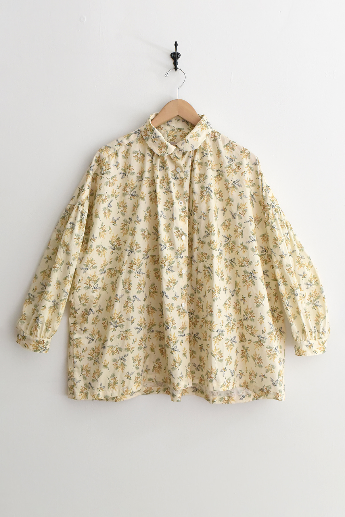 Women's lightweight cotton blouse with mimosa floral print, round collar, button front, gathered sleeves, and back yoke gathers