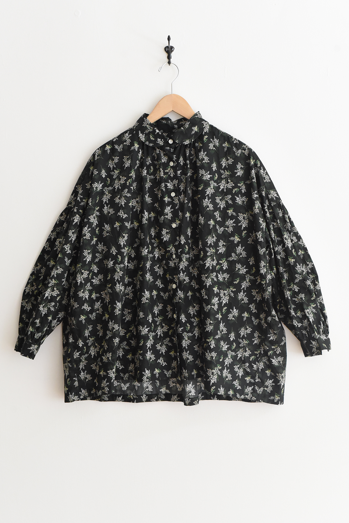 Women's lightweight cotton blouse with mimosa floral print, round collar, button front, gathered sleeves, and back yoke gathers