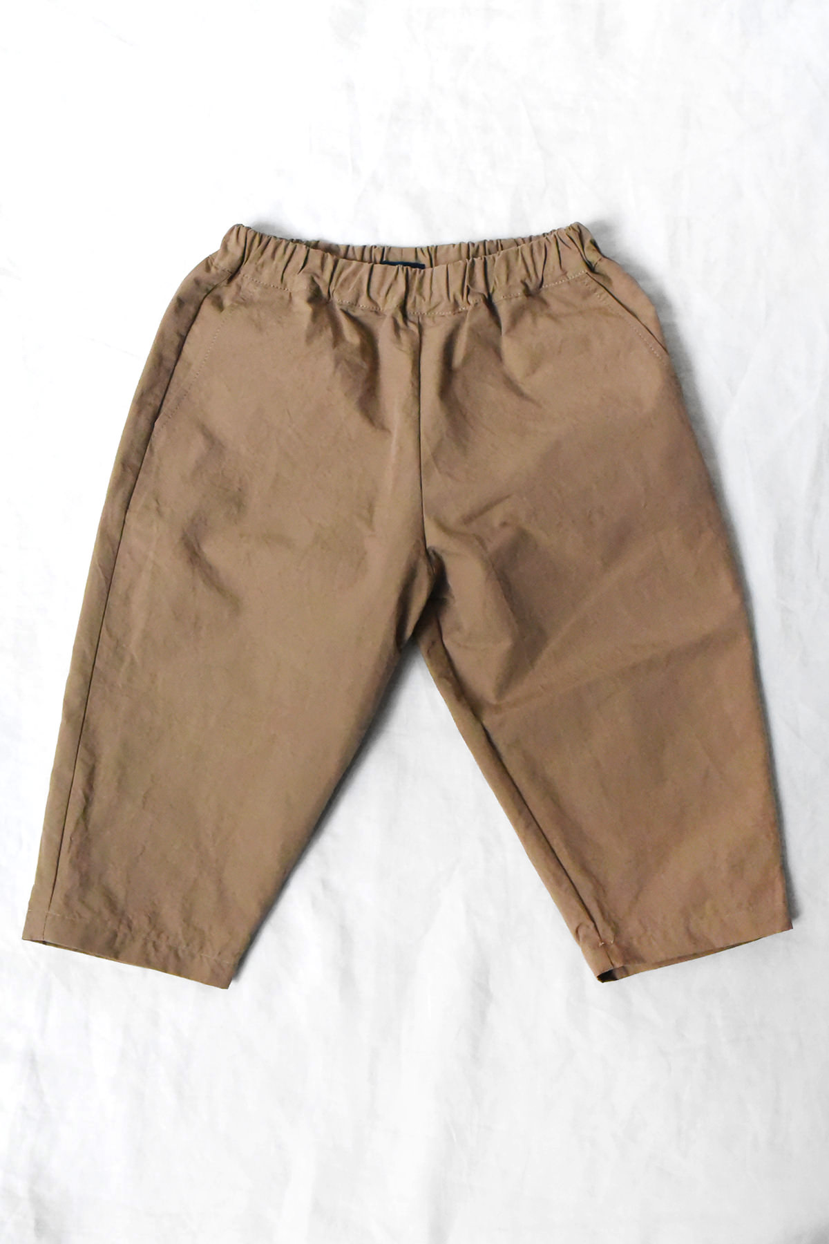 MAKIE Kairi kids cotton pants in beige with elastic waistband and relaxed fit