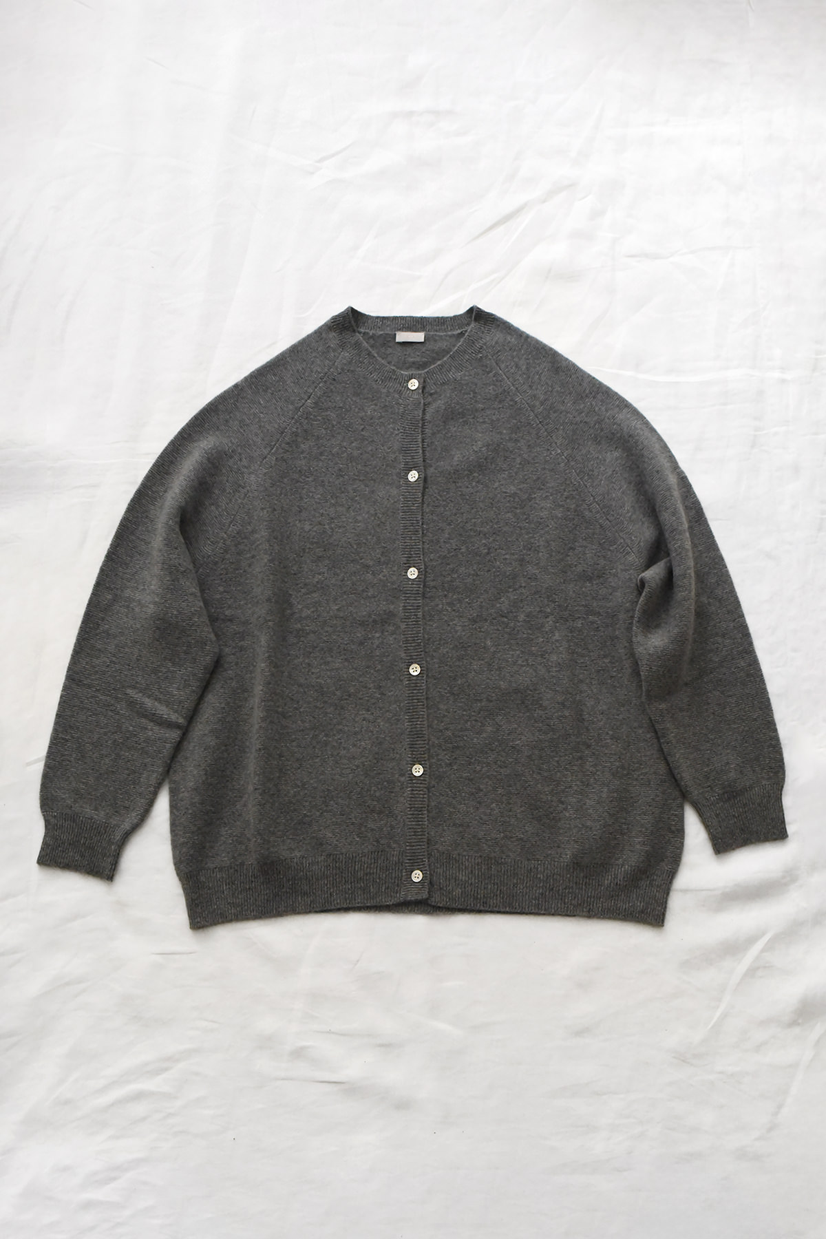 Women's gray cashmere raglan cardigan with crew neck, front button closure, and ribbed trims