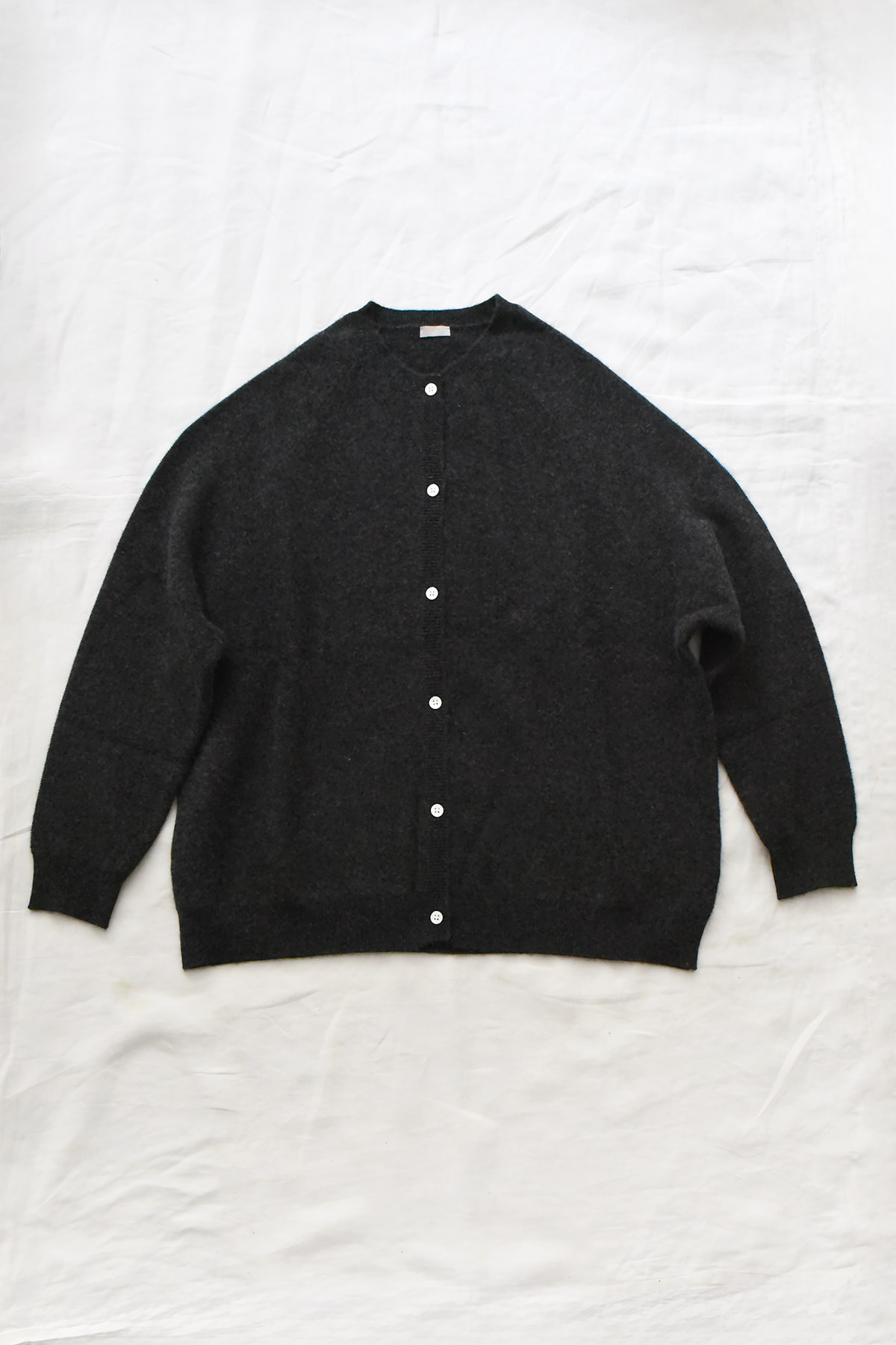 Women's charcoal cashmere raglan cardigan with crew neck, front button closure, and ribbed trims
