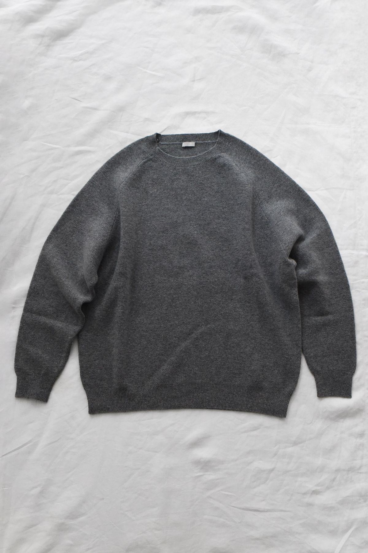 Women's navy cashmere back button sweater with raglan sleeves and crew neck