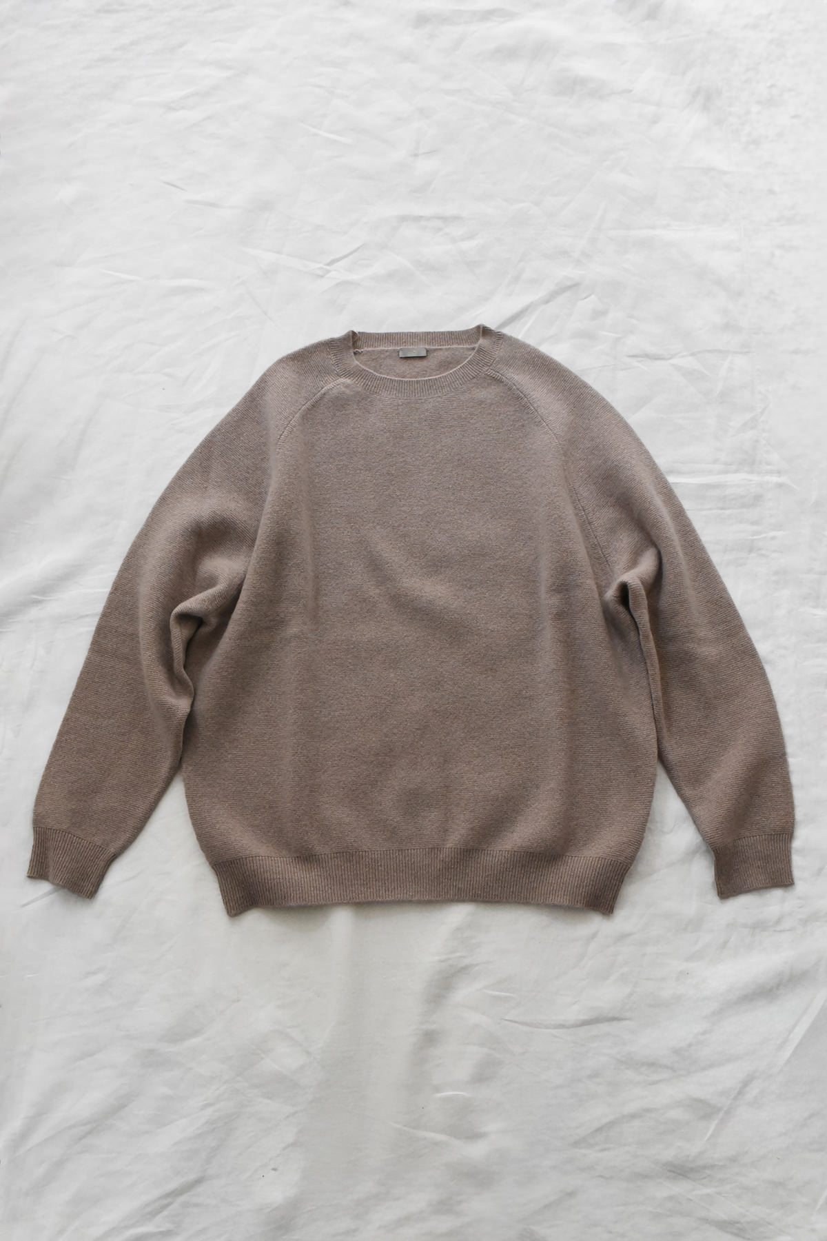Women's navy cashmere back button sweater with raglan sleeves and crew neck
