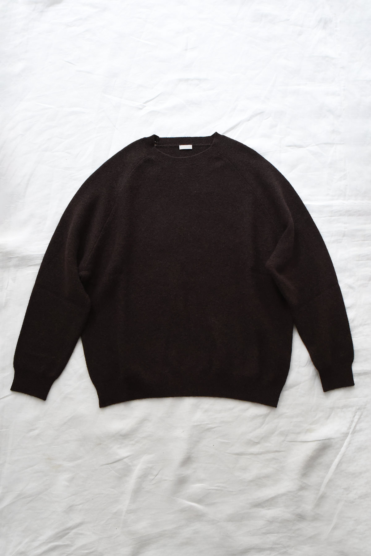 Women's navy cashmere back button sweater with raglan sleeves and crew neck