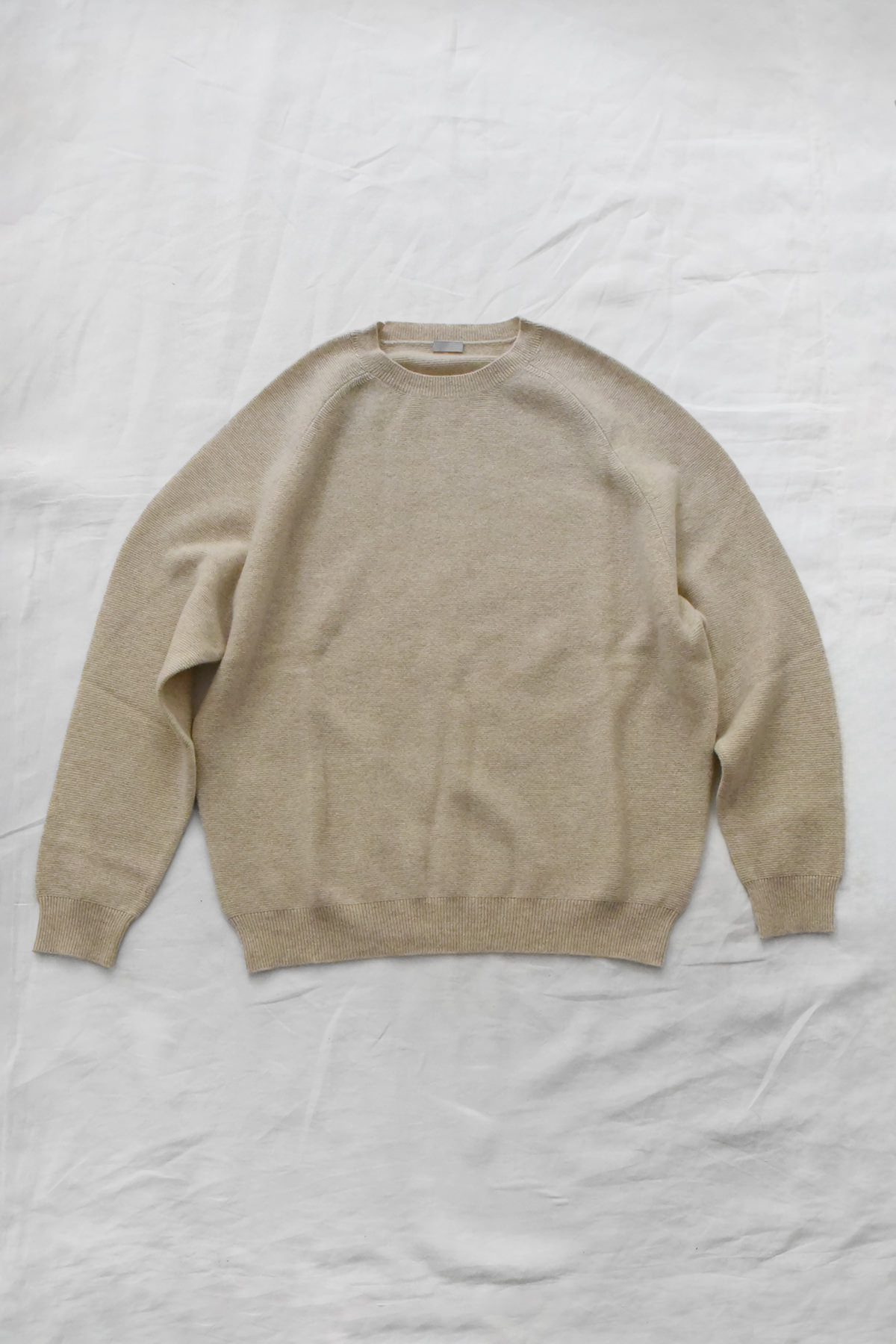 Women's navy cashmere back button sweater with raglan sleeves and crew neck