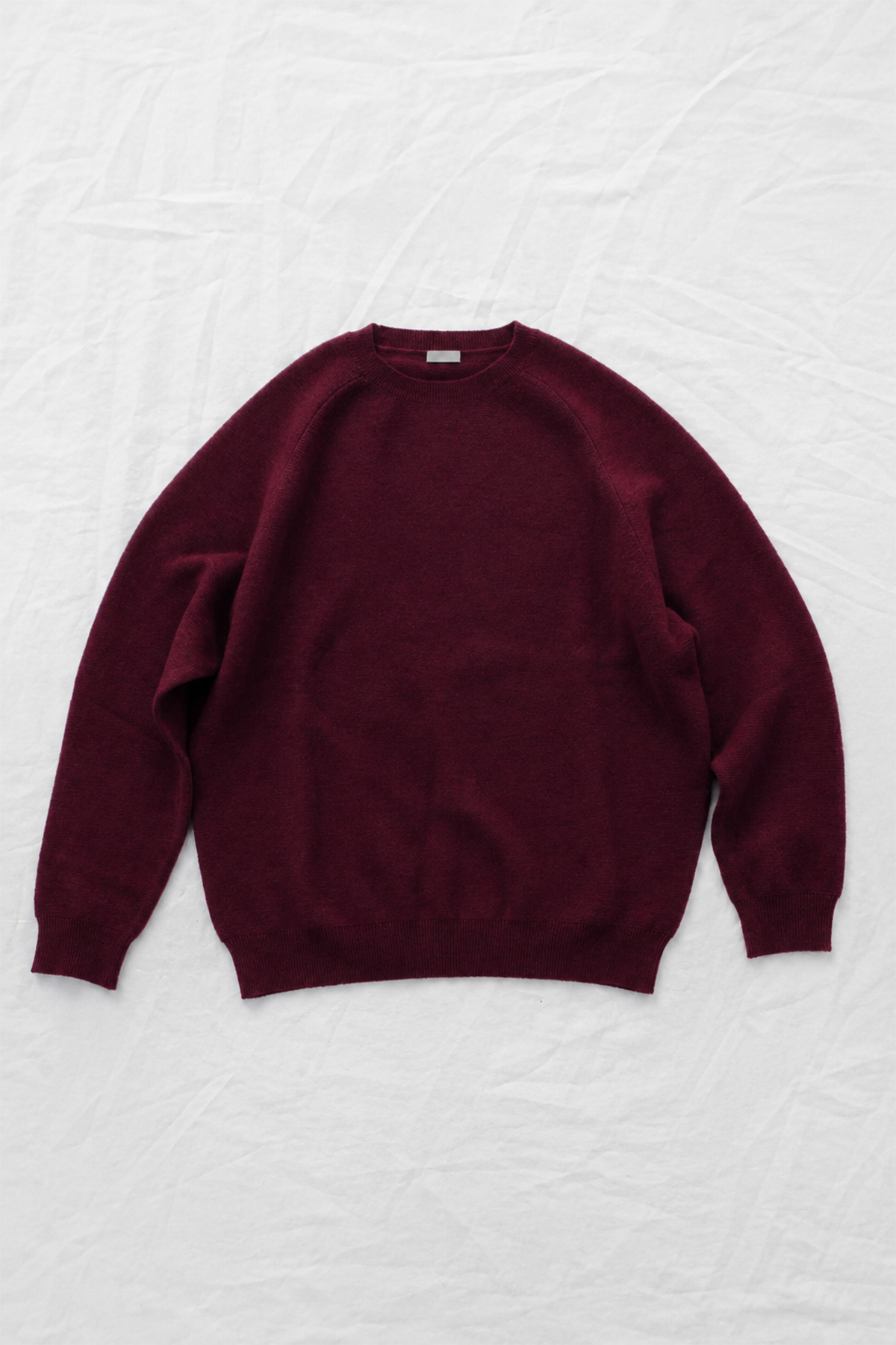 Women's burgundy cashmere back button sweater with raglan sleeves and crew neck