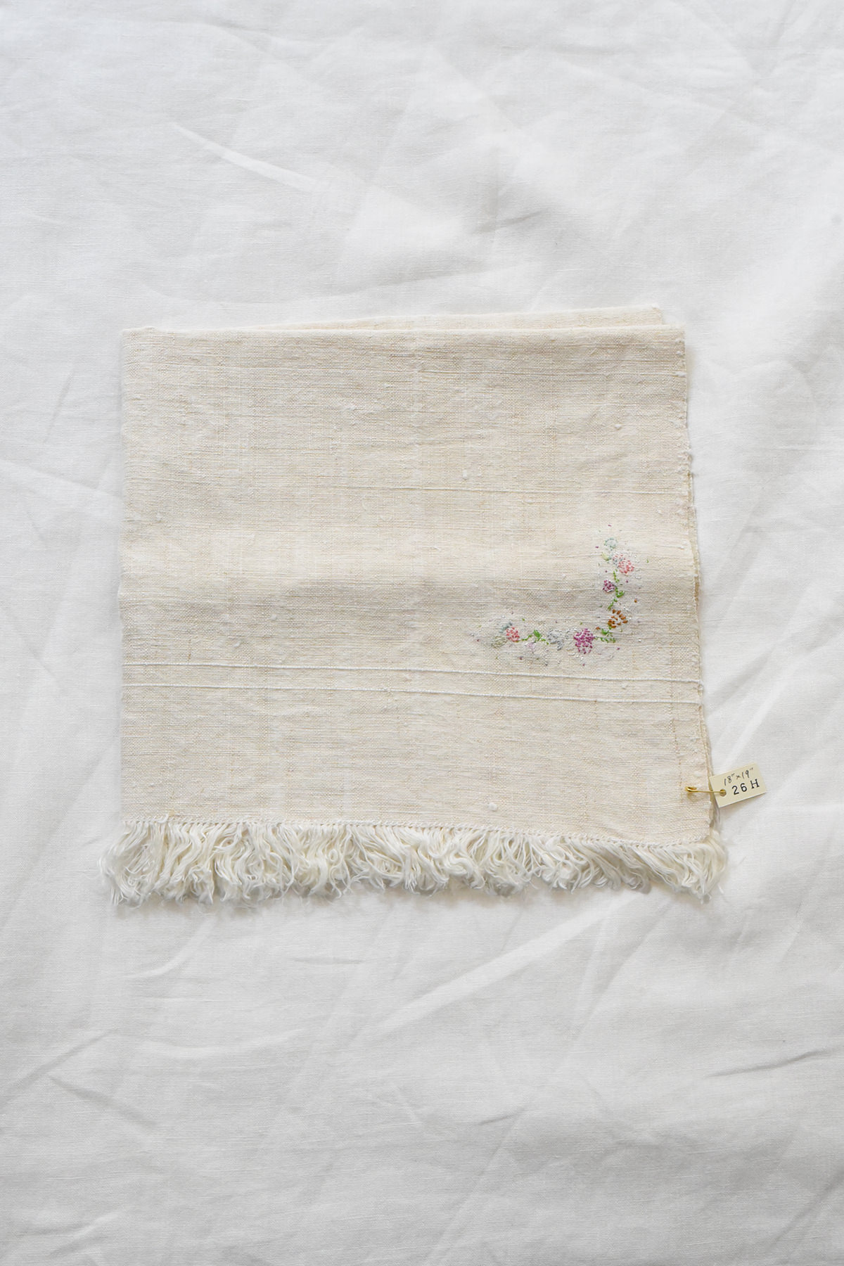 Hand embroidered vintage linen napkin with floral corner embroidery by Antonia Rossi