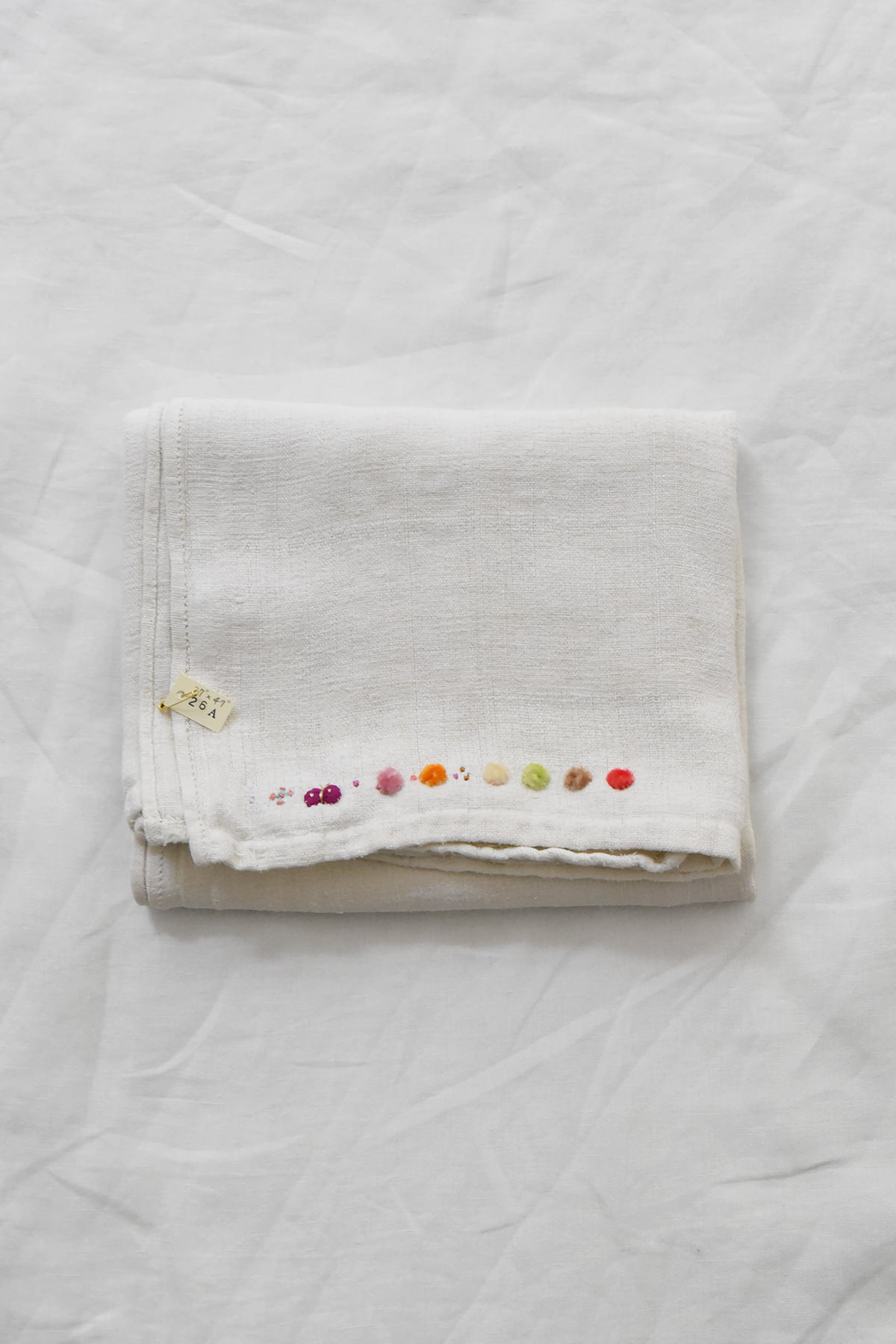 Hand embroidered vintage linen napkin with floral corner embroidery by Antonia Rossi