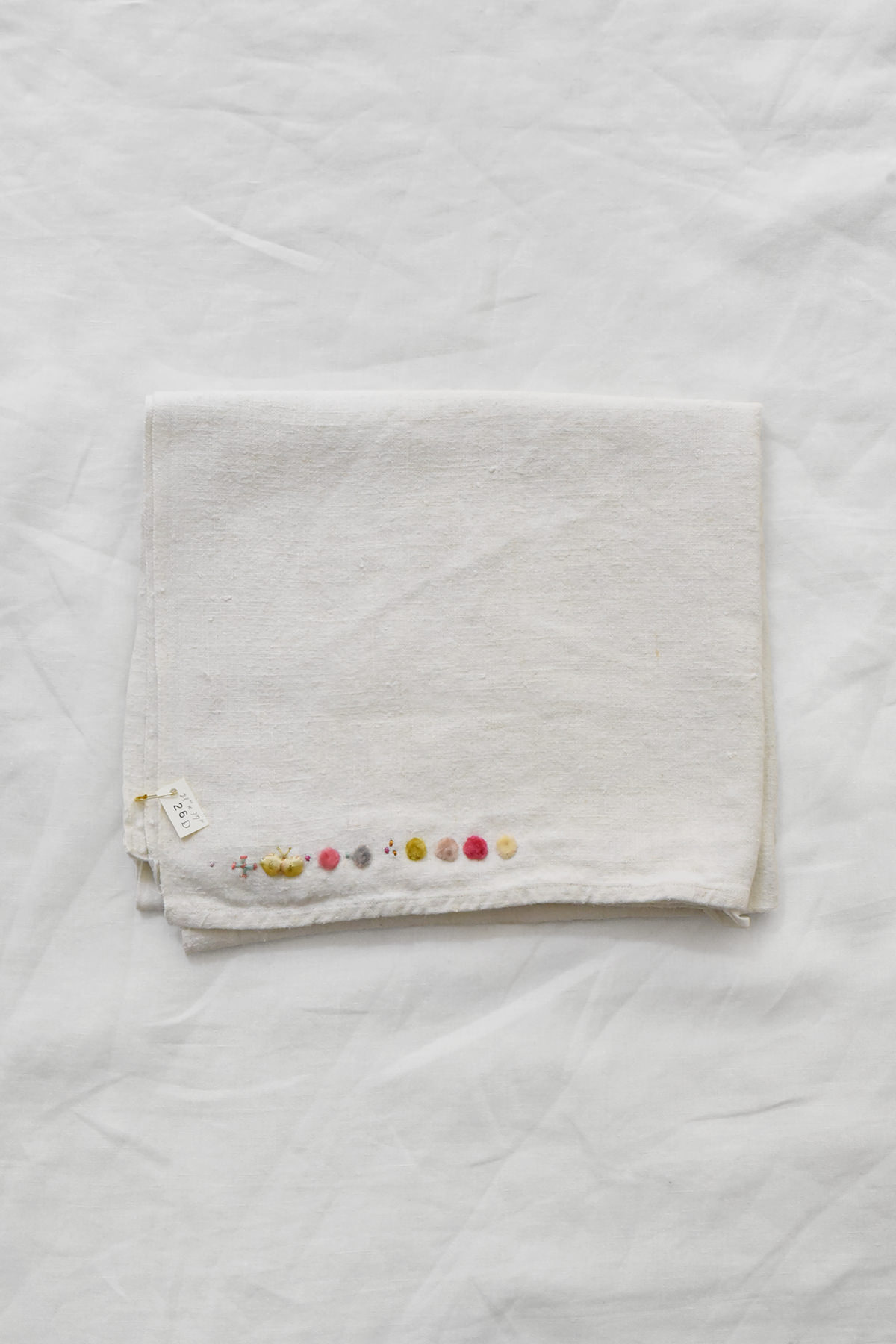 Hand embroidered vintage linen napkin with floral corner embroidery by Antonia Rossi