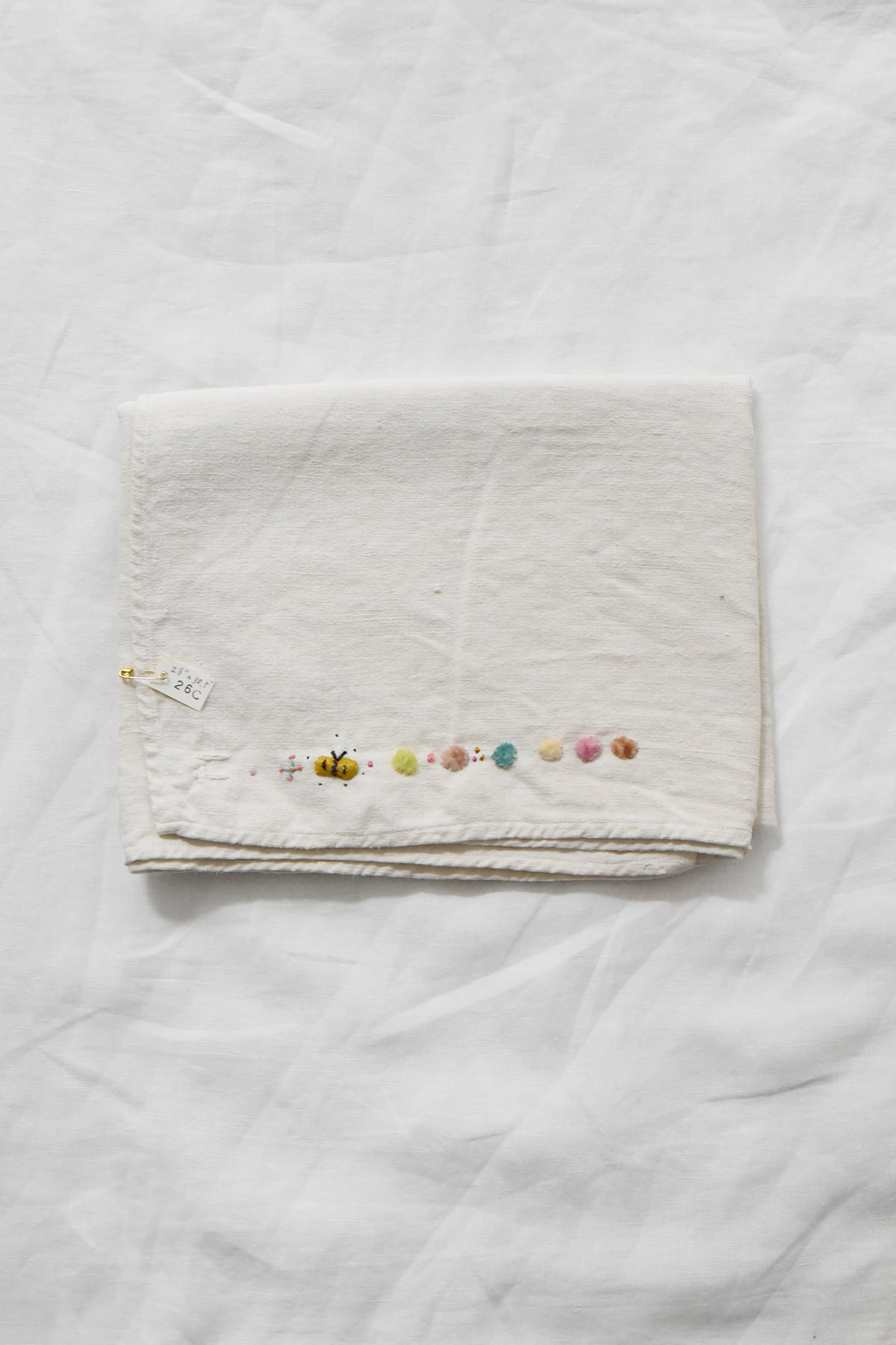 Hand embroidered vintage linen napkin with floral corner embroidery by Antonia Rossi