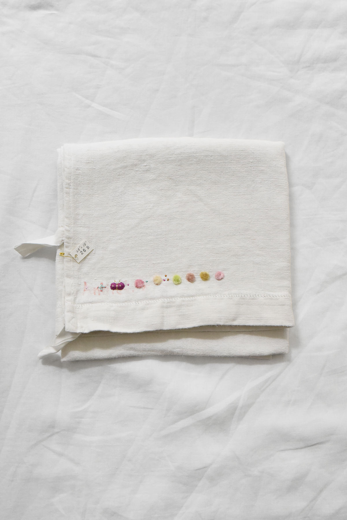 Hand embroidered vintage linen napkin with floral corner embroidery by Antonia Rossi
