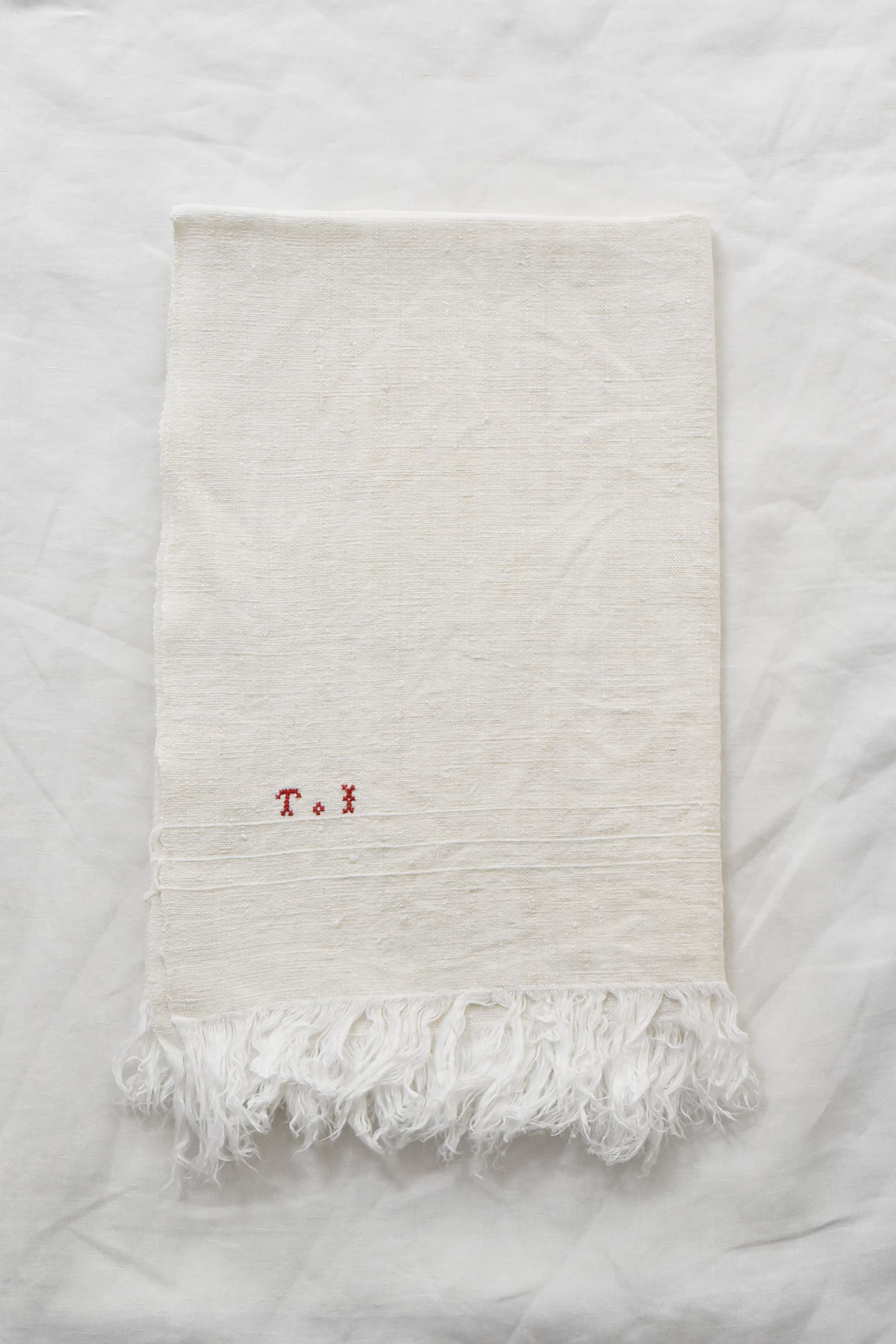 French vintage linen napkin with red embroidered initials and fringed edge