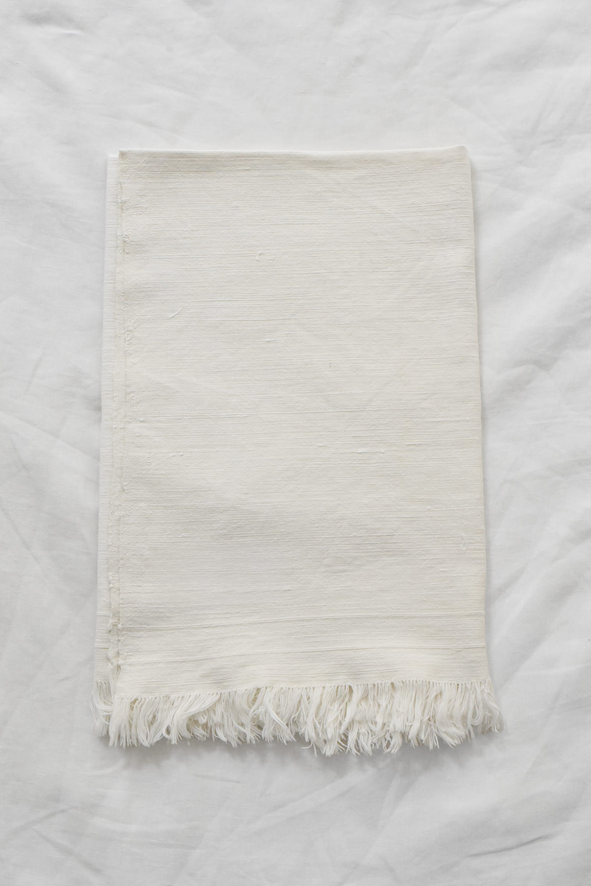 Vintage off-white linen napkin with fringed edges