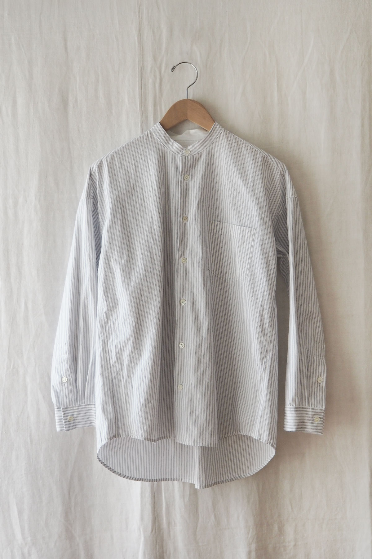 Stand collar and button front of cotton pinstripe shirt