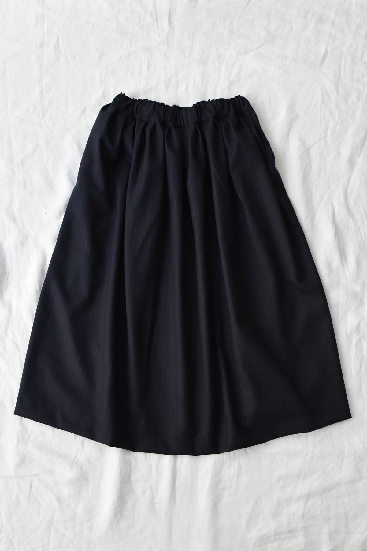 100% wool pleated skirt in navy pinstripe