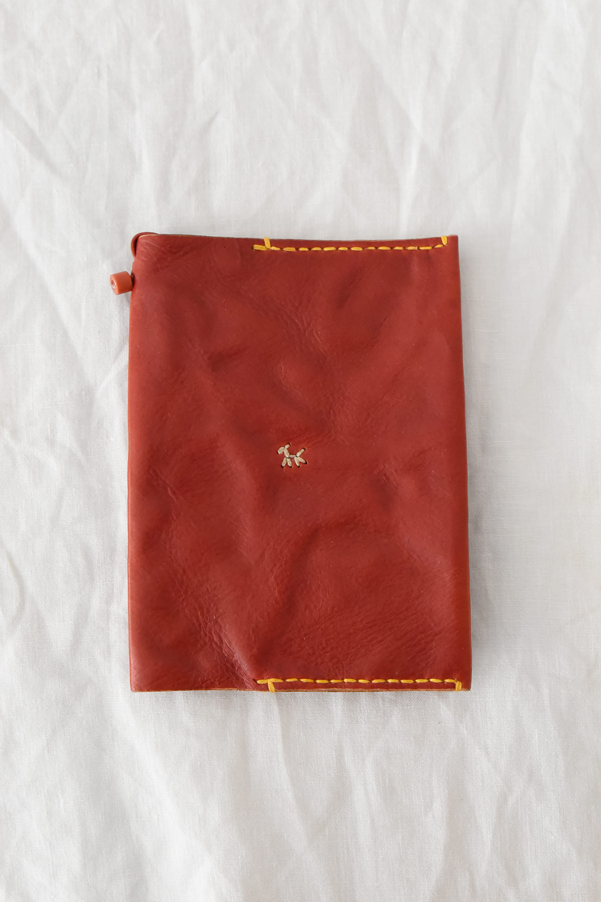 Henri red leather book and passport cover with yellow hand stitching