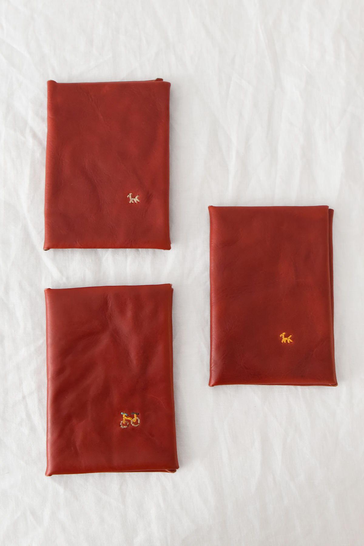 Folded Leather Wallet with Dog and Bicycle motif in red