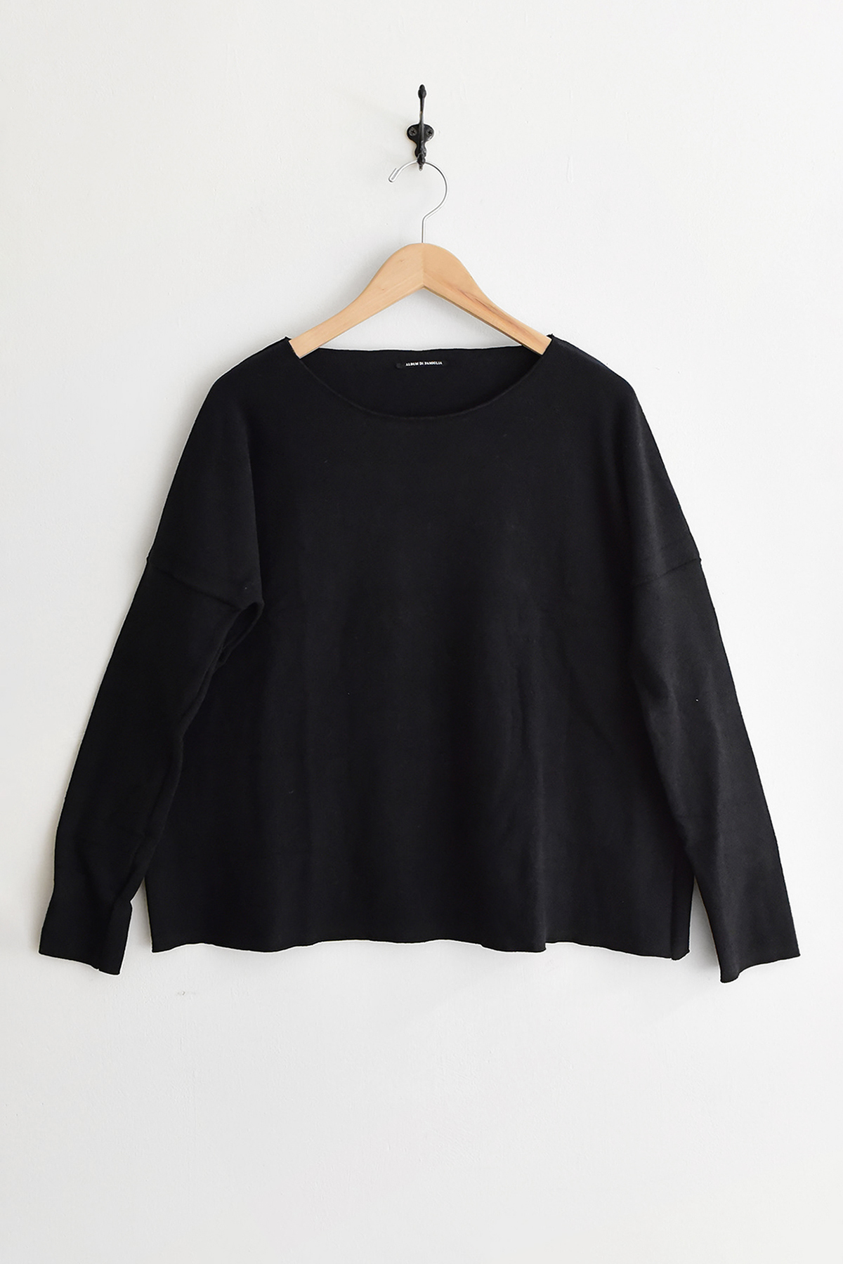 Album di Famiglia, 40_177 Jumper JP - Black long-sleeve pullover sweater with a wide neckline, hanging on a wooden hanger.