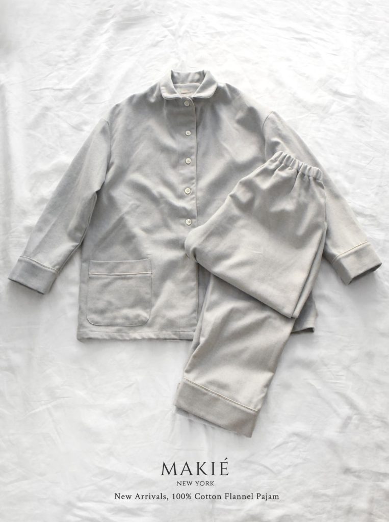 Light gray cotton flannel pajama set featuring a button-down shirt with pockets and matching pants, labeled MAKIÉ NEW YORK New Arrivals, 100% Cotton Flannel Pajam.
